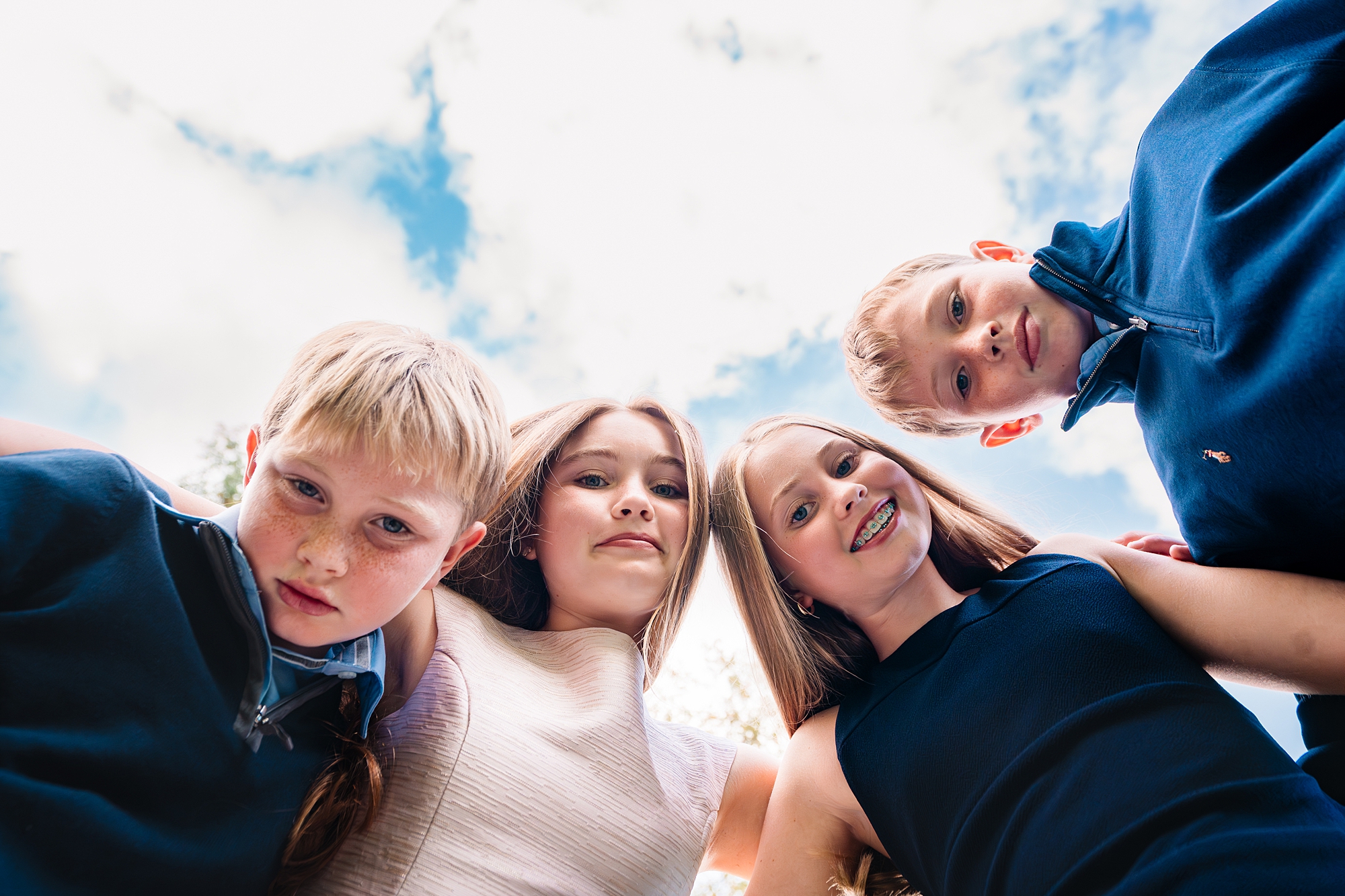 2 brothers and 2 sisters look down at the camera